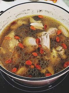 a pot filled with soup sitting on top of a stove