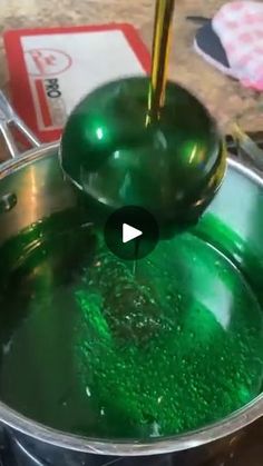 green liquid being stirred in a pot with a ladle