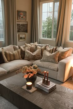 a living room filled with lots of furniture next to a window covered in drapes