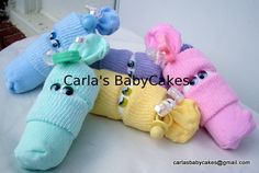 four knitted stuffed animals are sitting on a table together with the caption cartia's baby socks