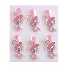 six pink and white paper clips with bows on each one, in the shape of an elephant