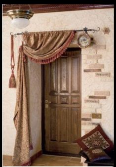 a wooden door sitting next to a window covered in curtains