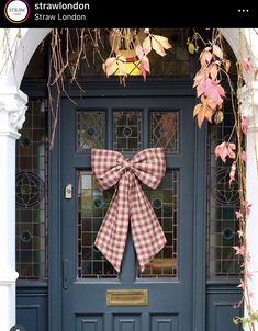 a blue front door with a large bow on it