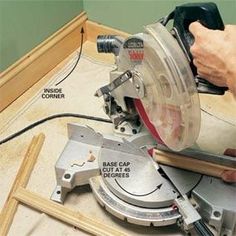 a person using a circular saw to cut wood