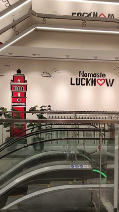 an escalator in the middle of a building with a sign above it that says namaste luckinow