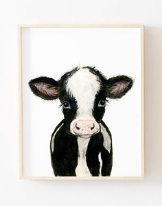 a painting of a black and white cow in a wooden frame on a wall above it's head