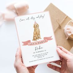 a person holding up a birthday card with a dog on it's front and back