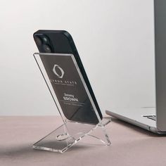 an award is placed next to a laptop on a table with a phone in it