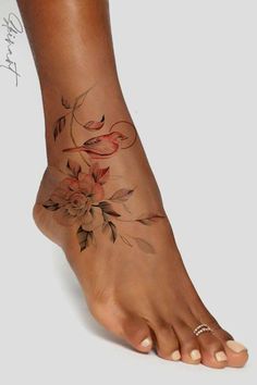 a woman's foot with flowers on it