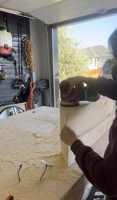 a woman sanding down a piece of wood