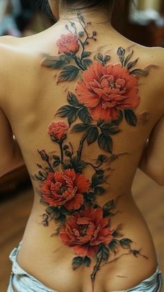 the back of a woman's body with red flowers on her chest and lower back