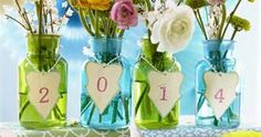 three vases with flowers in them sitting on a table