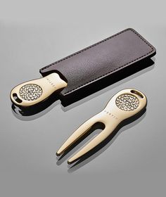 a pair of scissors sitting on top of a leather case next to a card holder