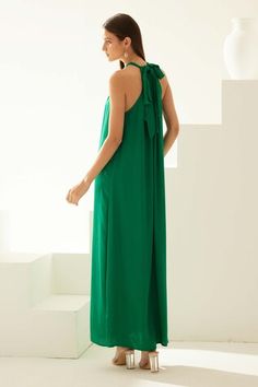 Green modal maxi dress with a halter neckline. - Aza Fashions Green Halter Maxi Dress For Evening, Chic Green Maxi Length Sleeveless Dress, Green Maxi Halter Dress For Evening, Green Maxi Length Halter Dress For Evening, Green Halter Neck Maxi Dress, Chic Green Halter Neck Maxi Dress, Pre-draped Halter Neck Maxi Dress For Evening, Green Halter Neck Beach Dress Cover-up, Summer Halter Neck Pre-draped Maxi Dress