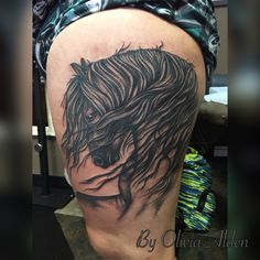 a woman's thigh with a horse tattoo on it