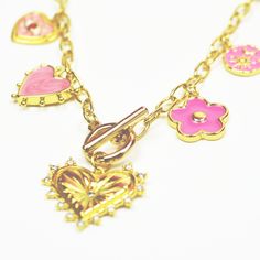 Beautiful toggle clasp charm necklace. They are made with 18K gold fill chain and charms. It's safe in water. The necklace consist of gold fill heart, pink daisy, pink heart, pink evil eye and pink moon & son charm. 17" long Fun Pink Charm Necklaces, Pink Dangle Charm Necklaces, Cute Pink Heart-shaped Charm Necklace, Playful Pink Charm Necklaces, Pink Enamel Charm Necklace, Pink Evil Eye, Pink Heart Necklace, Pink Charm, Pink Moon