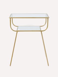 a glass table with gold legs and a clear top on a white background, side view