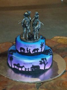 a three tiered cake decorated with silhouettes of people and animals on the side