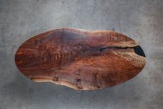 a piece of wood sitting on top of a cement floor