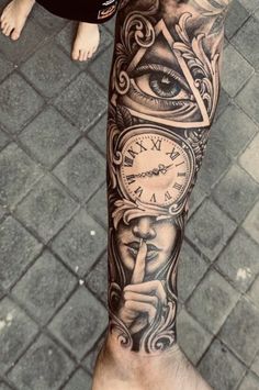 a man's arm with an all seeing eye tattoo on it and a clock