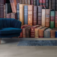 a blue chair sitting in front of a wall full of books on it's sides