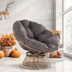 a chair that is sitting in the middle of a room with pumpkins on the floor