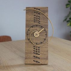 a wooden clock sitting on top of a table