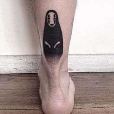 a person with a black cat tattoo on their leg