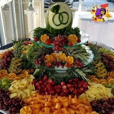 a platter filled with fruits and vegetables on top of a table