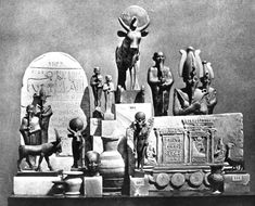 an old black and white photo of egyptian statues