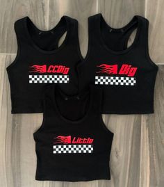 three black crop tops with red and white checkered logo on the front, two are sleeveless