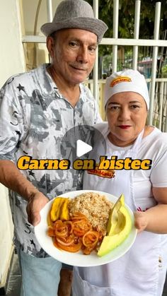 an older man and woman holding a plate of food with bananas, rice and meat on it