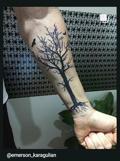 a person with a tree tattoo on their arm