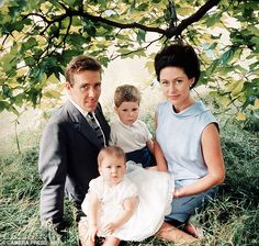 a family posing for a photo under a tree