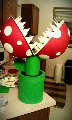 there is a mushroom on top of a green container in the middle of a kitchen