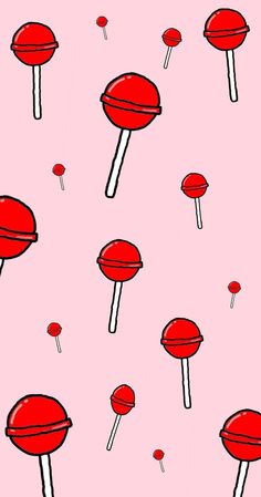 a pink background with lots of red lollipops