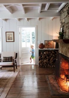 a little boy that is standing in front of a fire place