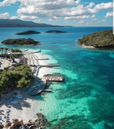 an aerial view of the beach and lagoons in front of some water with boats on it