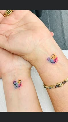 two people with matching tattoos on their wrists