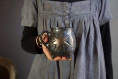 a woman holding a cup with a star on it