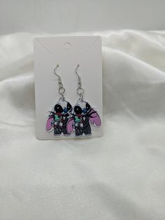 These cute mashup earrings are sure to delight any fan. A fun collision of two worlds. Light weight and comfortable. Printed on one side only. Themed Dangle Earrings, Fun Black Earrings, Playful Black Earrings For Gift, Fun Black Hypoallergenic Earrings, Black Hypoallergenic Fun Earrings, Two Worlds, Etsy Earrings Dangle, Cute Earrings, Jewelry Earrings Dangle