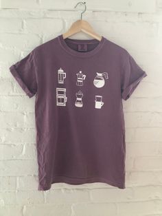 "Hand Printed and Hand Drawn! This is a 100% cotton screen printed graphic t shirt with various ways to brew coffee. This coffee tshirt listing is for a Comfort Colors 100% ringspun cotton, preshrunk, garment dyed tee. This is a thick but soft tee. The color is called berry. // PROCESS: All of our items are individually hand printed by either me or my dad, which can lead to slight variations in placement. The ink is heat cured and will not fade over time. Since our items are printed to order, th Coffee Color Short Sleeve T-shirt With Screen Print, Pre-shrunk Cotton Coffee Colored Tops, Pre-shrunk Cotton Coffee Tops, Coffee Cotton Graphic Tee, Coffee Colored Cotton Graphic Tee, Coffee Crew Neck Top With Screen Print, Coffee-colored Crew Neck Top With Screen Print, Coffee Cotton T-shirt With Screen Print, Coffee Colored Graphic Tee In Cotton