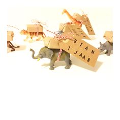 an elephant and some giraffes are in front of a sign that says sitan jaar