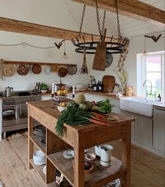 a kitchen filled with lots of wooden furniture