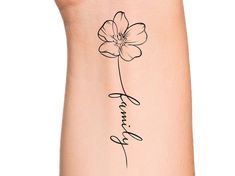 a woman's arm with a flower tattoo on it