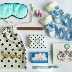 the contents of a sleeping mask and accessories laid out on a white surface with blue eyeshades