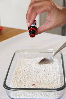 a person is dipping something into a bowl with white rice and red pepper in it