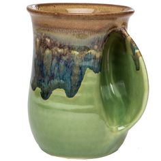 a green and brown ceramic mug with handle