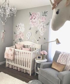 This baby girls nursery is so beautiful with so many unique elements. The floral decals on the wall are gorgeous and compliment the chandelier perfectly. That crib and bedding are beautiful and the unicorn is too cute! Dekorasi Kamar Tidur, Nursery Decor Girl, Baby Nursery Decor