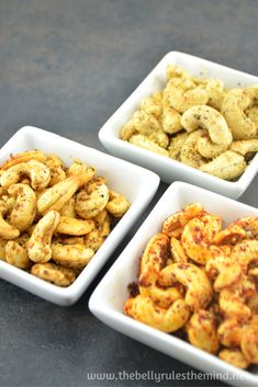 three white bowls filled with different types of food on top of a black countertop